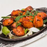 Tandoori Chicken Tikka · Earthen oven grilled chicken with creamy coating. Served with basmati rice.