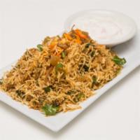 Chicken Biryani · Slow cooked basmati rice, saffron, cardamom, and bay leaf. Served with cucumber raita.