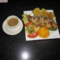 Mojarra Frita (Tilipia) · Fried tilapia, mix salad and green plantains.
