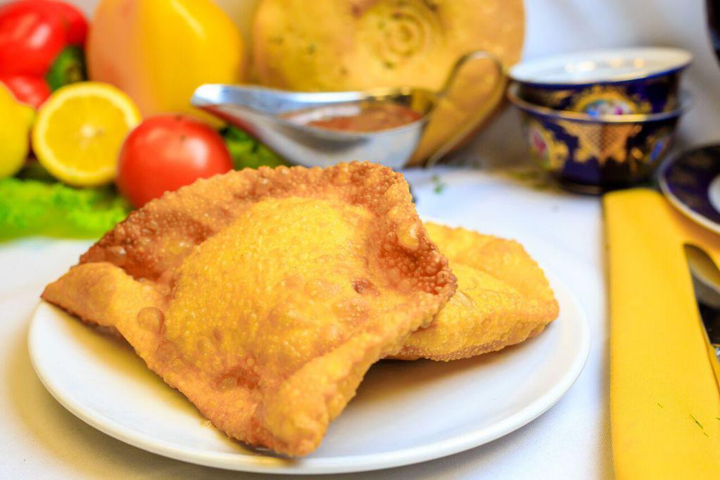 Cheburek · Deep fried turnover stuffed with a traditional blend of ground lamb and beef.
Served with a side of fresh tomato and garlic sauce 