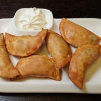 Fried Potato Pierogi  · 5 pieces. Served with side of sour cream and caramelized onions. 