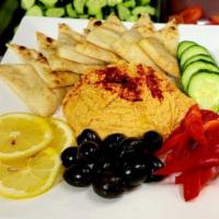 Hummus · Served with Pita chips, black olives, cucumber, red peppers & lemon slices.