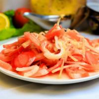 Achchik-Chuchuk · Freshly sliced tomato and onion salad, garnished with Cayenne pepper and Sea salt, dressed w...