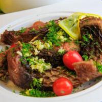 Uzbek traditional Fried Carp · Hand battered and flash fried bone in Carp steak tossed in a cilantro-garlic sauce 