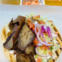 Lamb Gyro · fresh tender Lamb cooks in slow fire served with lettuce tomatoes onions & white sauce