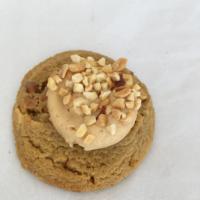 Peanut butter cookie · Peanut butter cookie topped with peanut butter cream cheese dipped in peanuts.