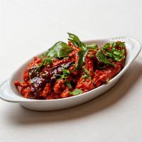 Chicken 65 · Chicken deep-fried with punchy flavors of curry leaves, ginger, garlic, chilies and spices.
