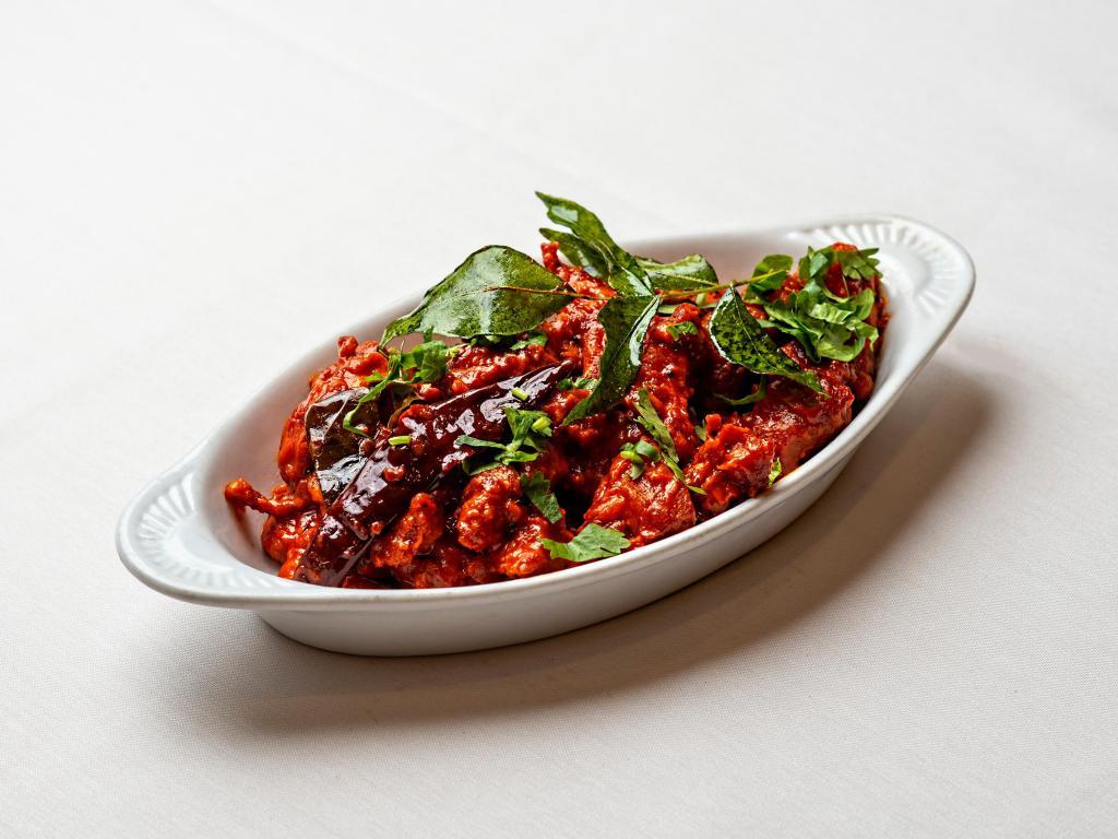 Chicken 65 · Chicken deep-fried with punchy flavors of curry leaves, ginger, garlic, chilies and spices.