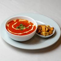 Tomato Soup · Fresh tomatoes sauteed with onions, cardamom and finished with touch of cream and lemon.