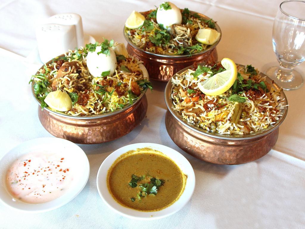 Dum Biryani Vegetables · Different layers with fried onions, fresh cilantro and mint cooked in traditional dum puhkt method on slow heat.