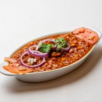 Chana Masala · Chickpeas and tomatoes cooked in traditional spices.