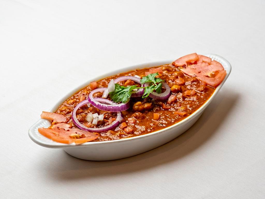 Chana Masala · Chickpeas and tomatoes cooked in traditional spices.