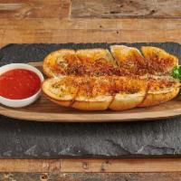 26. Garlic Bread · Buttery bread that is topped with garlic. Add mozzarella for an additional charge.