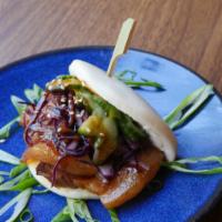 Two Braised Pork Belly Buns · Two baos with braised pork belly, cabbage, peanuts, black sesame seeds, and sauce