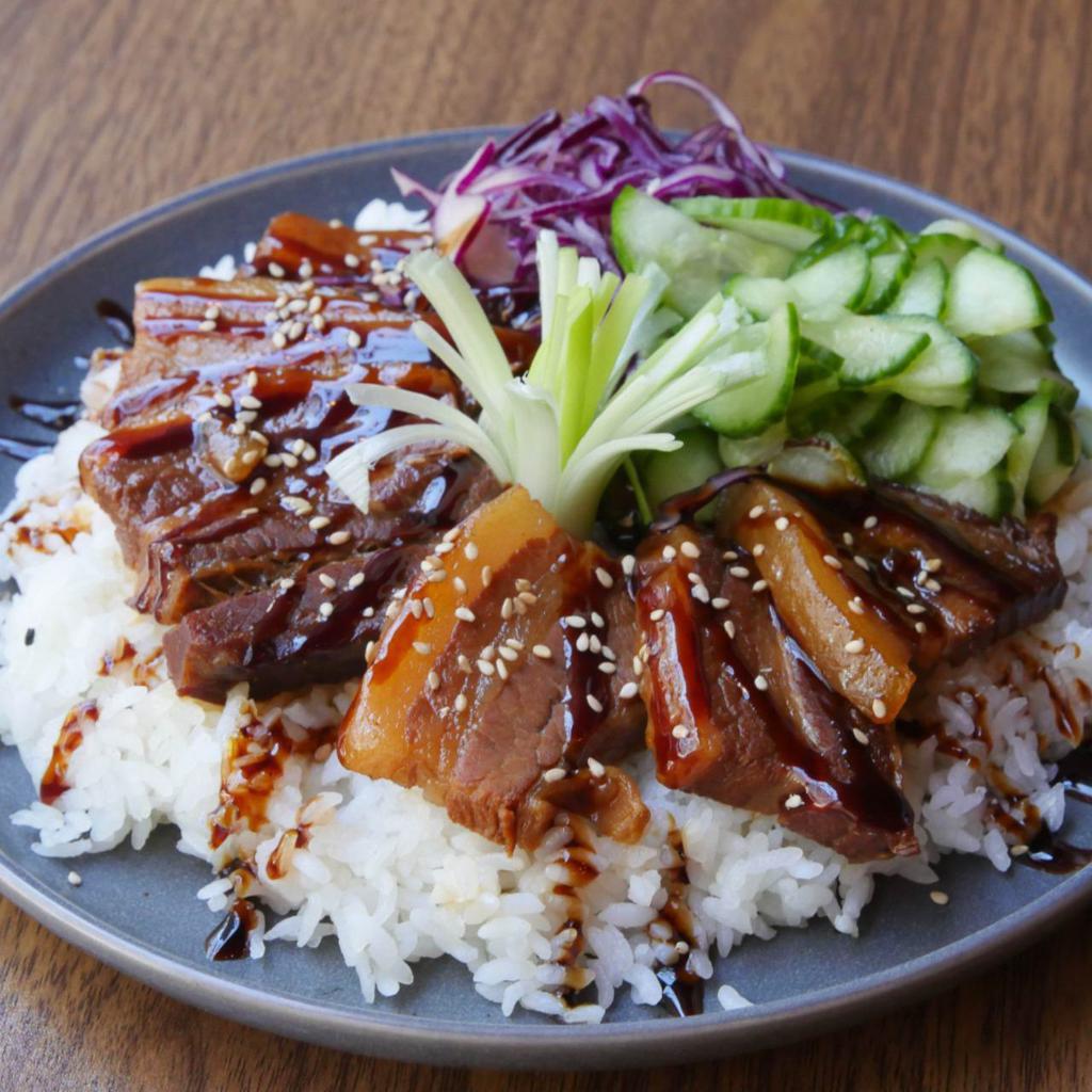 Braised Pork Belly Bowl · Braised pork belly with cabbage slaw, cucumbers, and choice of base.