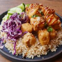 Crispy Glazed Tofu Bowl · Olive oil fried tofu seasoned with five spice with cabbage slaw, cucumbers, and choice of ba...