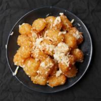 Truffle Parmesan Tots · Tater tots with fresh parmesan cheese, white truffle oil and chives.