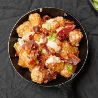 Bacon Truffle Tots · Tater tots with zesty truffle aioli, bacon crumble, and chives.
