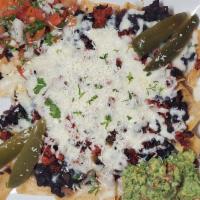 Nachos Locos · Tortilla chips topped with jack cheese cheddar black beans, Pico de Gallo, guacamole. And ho...