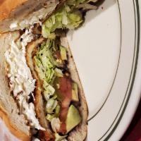 Torta De Jamon Con Queso Oaxaca · Cheese and ham sandwich. Served with beans, lettuce, tomatoes, jalapenos, avocado and mayonn...