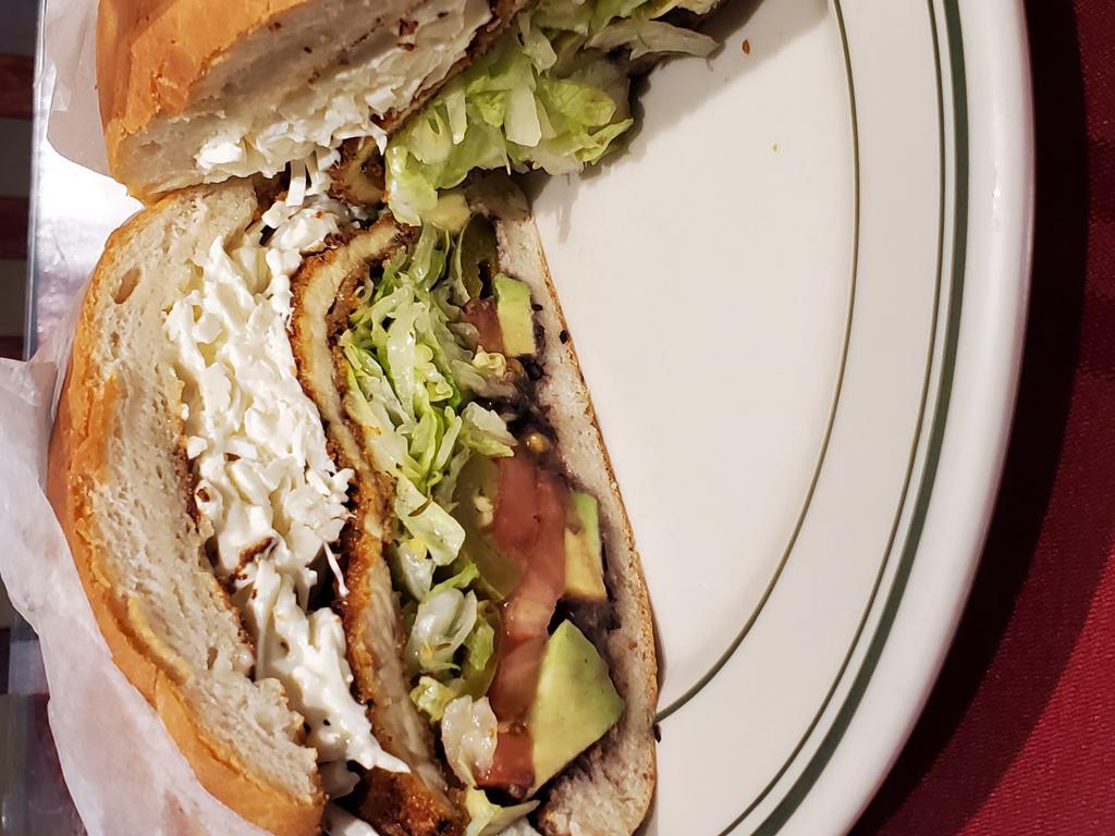 Torta De Jamon Con Queso Oaxaca · Cheese and ham sandwich. Served with beans, lettuce, tomatoes, jalapenos, avocado and mayonnaise.queso oaxaca