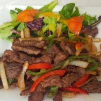 Pepper Steak (Bistec Salteado) · Sirloin Steak strips sauteed with onions, red and green peppers, with a touch of garlic, ore...