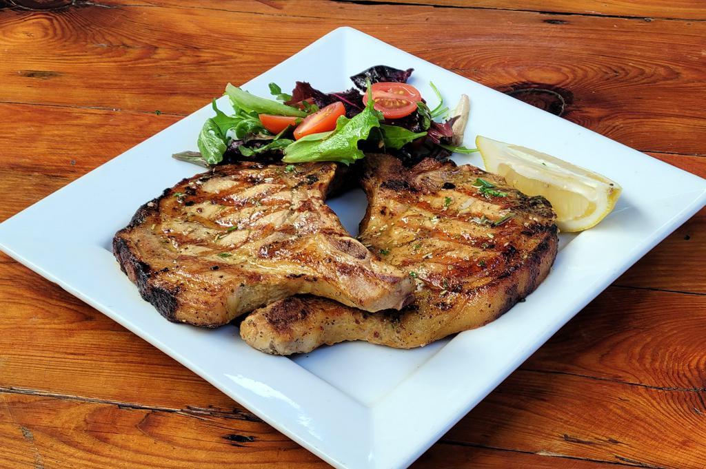 Grilled Pork Chops (Chuleta a la Parrilla) · A pair of pork chops slowly grilled with a splash of fresh lime. Served with your choice of side. 