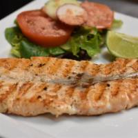 Grilled Salmon (Salmon a la Parrilla) · A fillet of salmon flat iron cooked simply with salt, pepper and a splash of lime. Served wi...