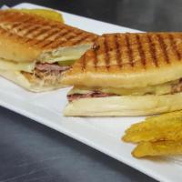 Cuban Sandwich (Cubano) · Juicy and tender roast pork, ham, Swiss cheese, pickles and mustard on a 
crunchy Italian h...