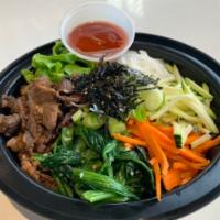 Korean Beef Bibimbap 불고기 비빔밥 · Served with seasoned rice, fresh greens, seasonal veggies, and gochujang chili paste