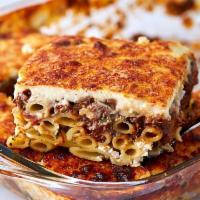 Pastitsio · Baked pasta dish with ground beef and Bechamel sauce. Served with a small Greek salad and wa...