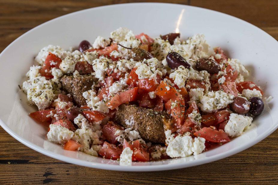 Dakos Salad (32oz.) · Barley rusks topped with chopped tomatoes, crumbled feta cheese, olives and oregano. Drizzled with olive oil.