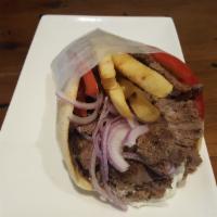 Lamb Pita Combo · Slow-roasted rotisserie lamb. Stuffed with tomatoes, red onions, french fries and choice of ...