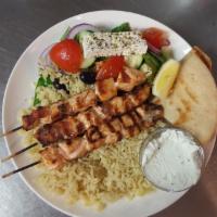 3 Grilled Salmon Sticks over Rice or Potatoes · 3 marinated and char-grilled salmon on a stick over rice. Served with Greek salad and warm p...