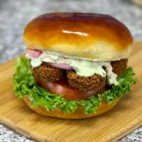 The Vegetarian Burger + Fries · Golden crisp falafel bites, hummus spread, tomato, lettuce, pickled onion, pickles, garlic s...