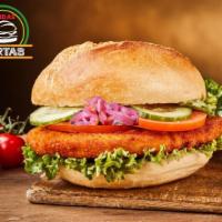 Milanesa Torta · Breaded chicken breast deep-fried to render a crispy bite, garnished with red pickled onions...