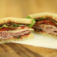 The Italian Sandwich · Shaved genoa salami and smoked ham topped with a roasted pepper black olive tapenade and pro...