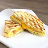 Breakfast Egg Sandwich · Scrambled egg, garlic herb spread and either ham or bacon and your choice of Swiss, cheddar,...