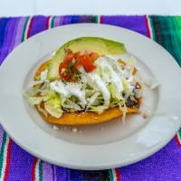 Plain tostada  · fried corn tortilla served with black beans, lettuce, sour cream, and cotija cheese, avocado 