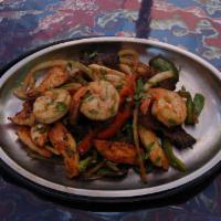 Mixed Fajitas Platter · A mix fajita served with shrimp, steak, chicken onions bell peppers  