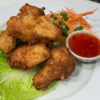 2. Thai Chicken Wing · 6 pieces. Our very own marinated chicken wings served with sweet chili sauce.