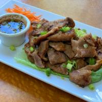 9. Moo Ping · Grilled marinated pork with spicy Thai dipping sauce.