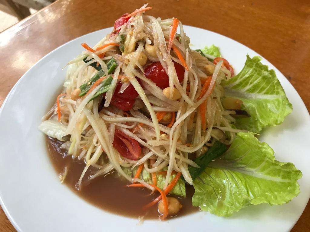 19. Papaya Salad · Sour chili lime sauce wonderfully blended in a mix of shredded green papaya, cherry tomato, string beans and peanuts.