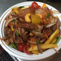 23. Crispy Duck Salad · Roasted duck, tomato, red onion, pineapple, scallion, cilantro tossed in fresh chili lime sa...