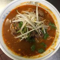 44. Spicy Tom Yum Noodle Soup · Tom yum noodle with ground peanuts, bean sprouts, scallions and cilantro with choice of thin...