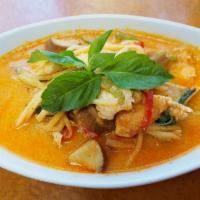 54. Red Curry · Smooth creamy coconut milk is matched with hot fiery chili paste, eggplant, bamboo shoot, ba...