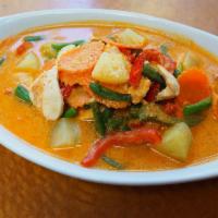 57. Panang Curry · Lightly sweet and spicy with pineapple, string beans, carrots and lime leaves.served with ja...