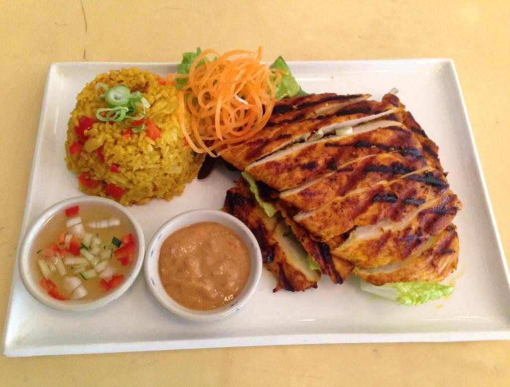 76. Chicken Turmeric with Peanut Sauce · Grilled marinated chicken breast served with curry fried rice.