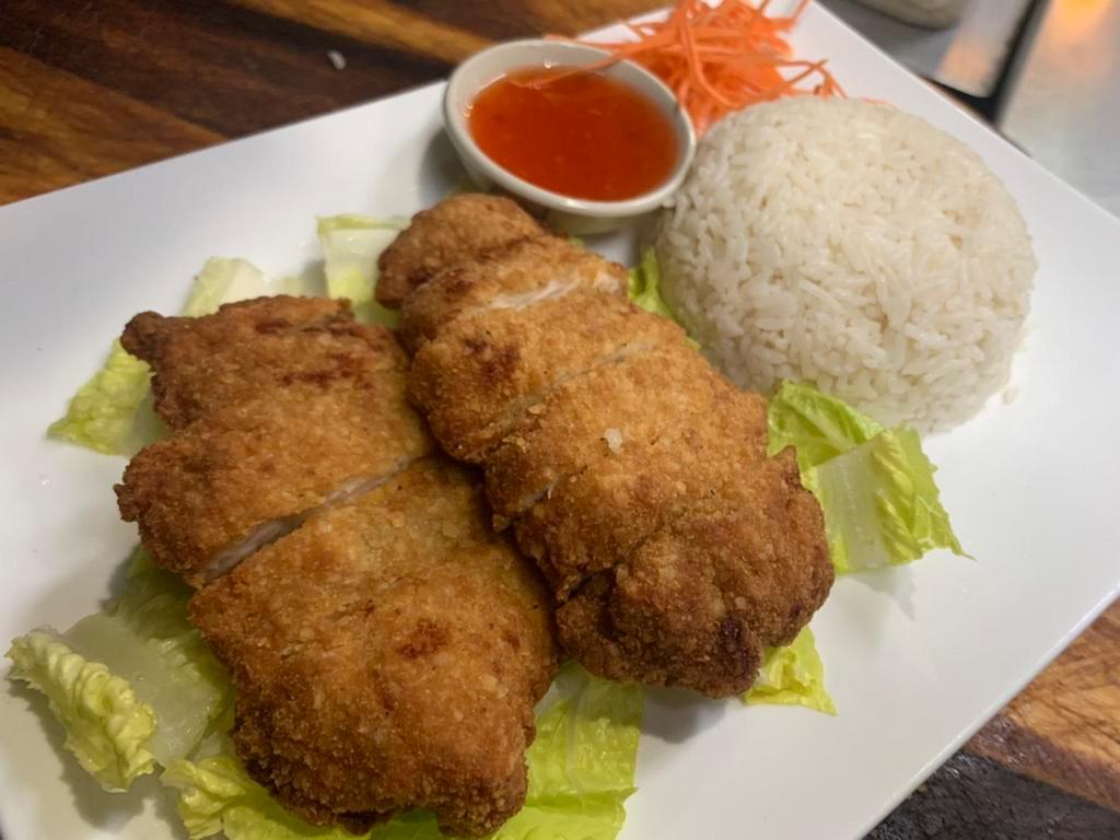 69. Chicken Comfort · Crispy boneless chicken breast on top of rich coconut rice and salad served with hot sweet chili sauce.