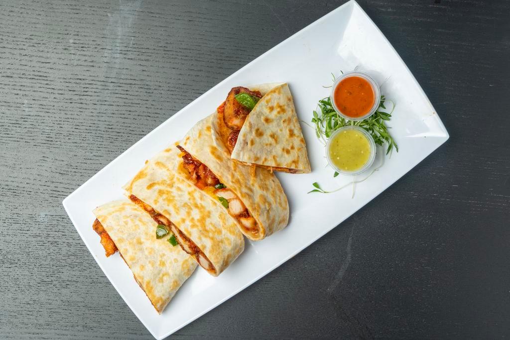 KFC Quesadillas · Pan fried Quesadilla filled with Fried Chicken, jalapenos, caramelized onions, cheese, kimchi, spicy Korean sauce, and cilantro.  Served with a side of Salsa Roja, Salsa Verde, and Yuzu Elote